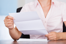 woman opening letter